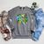 Green Sea Turtle Surfs Past a Canoe Paddle Sleeveless Raglan Sleeve Sweatshirt Deep Heather