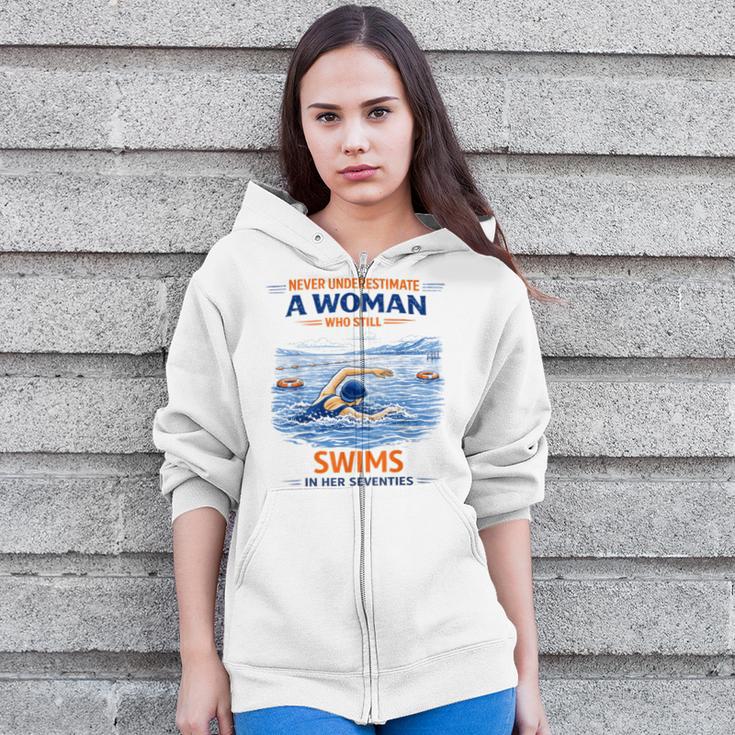 Swimming Never Underestimate A Woman Swim In Her Seventies Zip Up Hoodie Swimming Never Underestimate A Woman Swim In Her Seventies Zip Up Hoodie